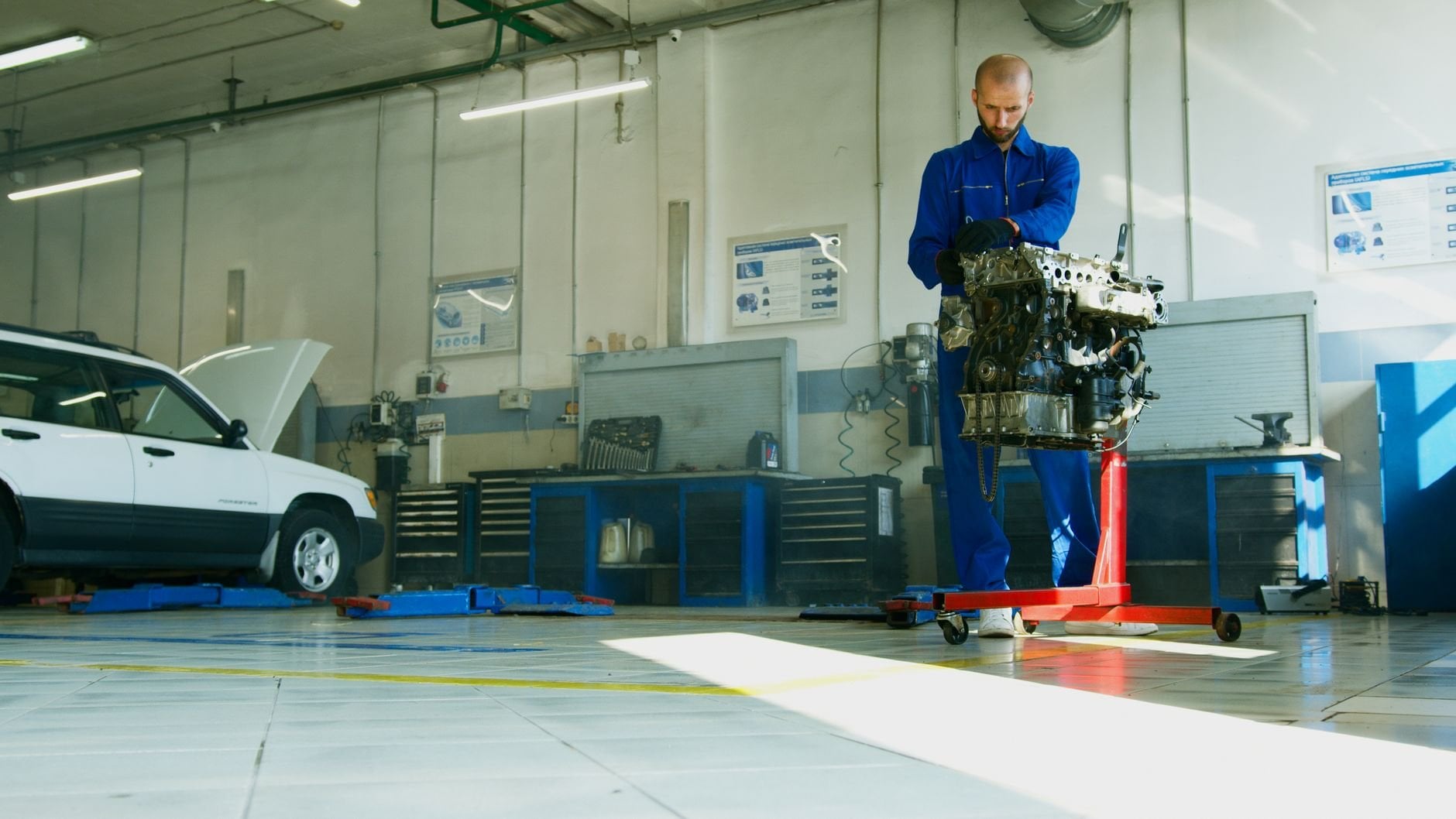 Professional mechanic inspecting car engine in auto repair shop